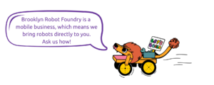 Color illustration of the Bambino Beast, a lion-like robot, with a sign that says “Let’s Build” and a speech bubble that says “Brooklyn Robot Foundry is a mobile business, which means we bring the robots directly to you. Ask us how!” The text is in purple lettering.