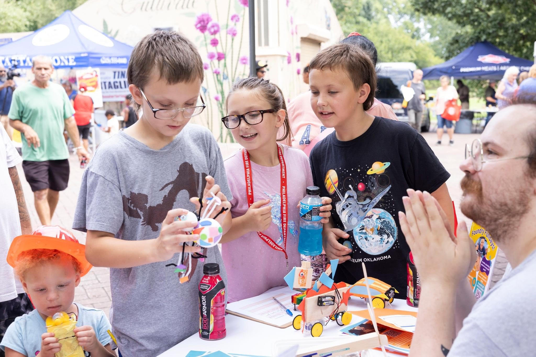 Three kids exploring hands-on robotics