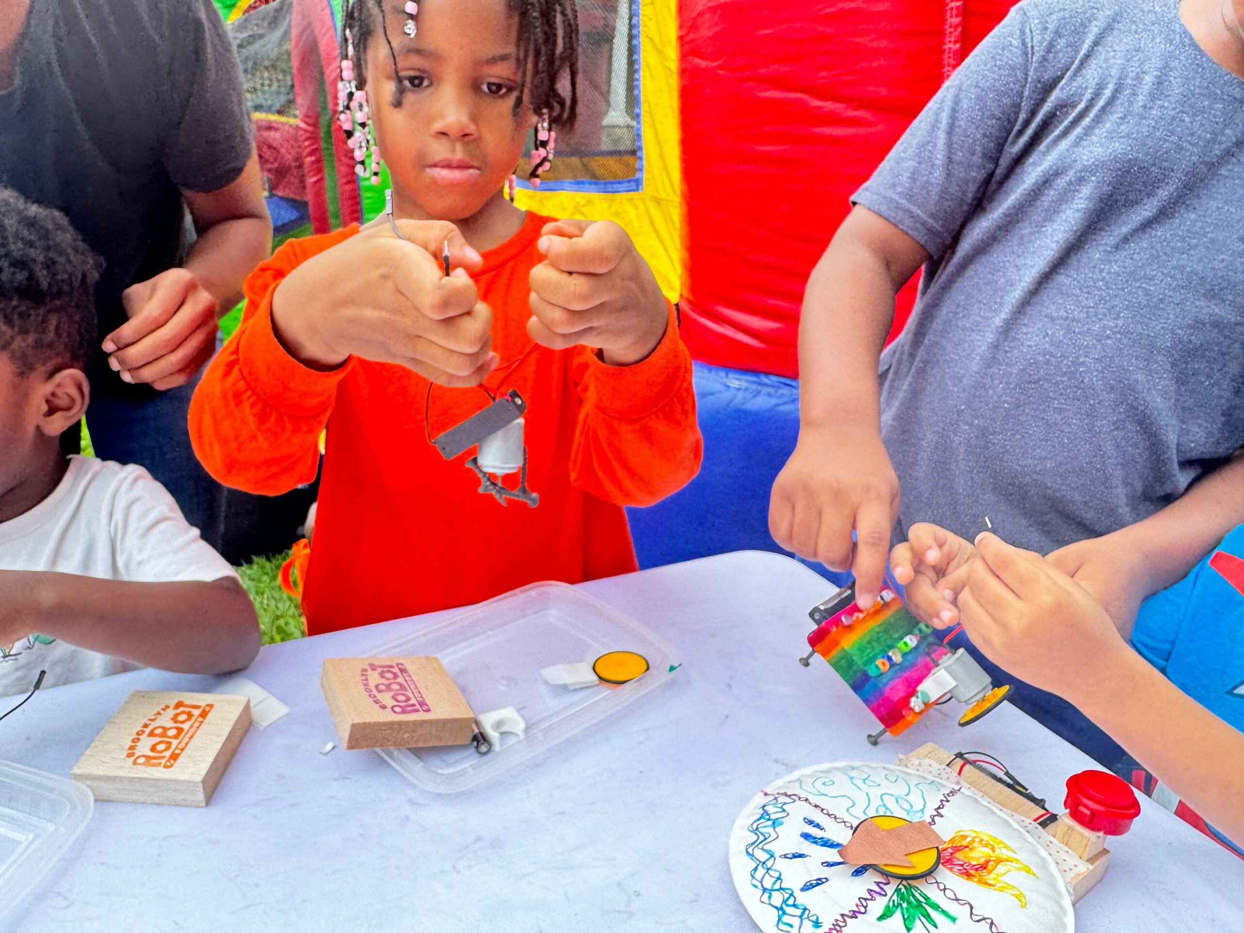 Kids looking at circuitry wires