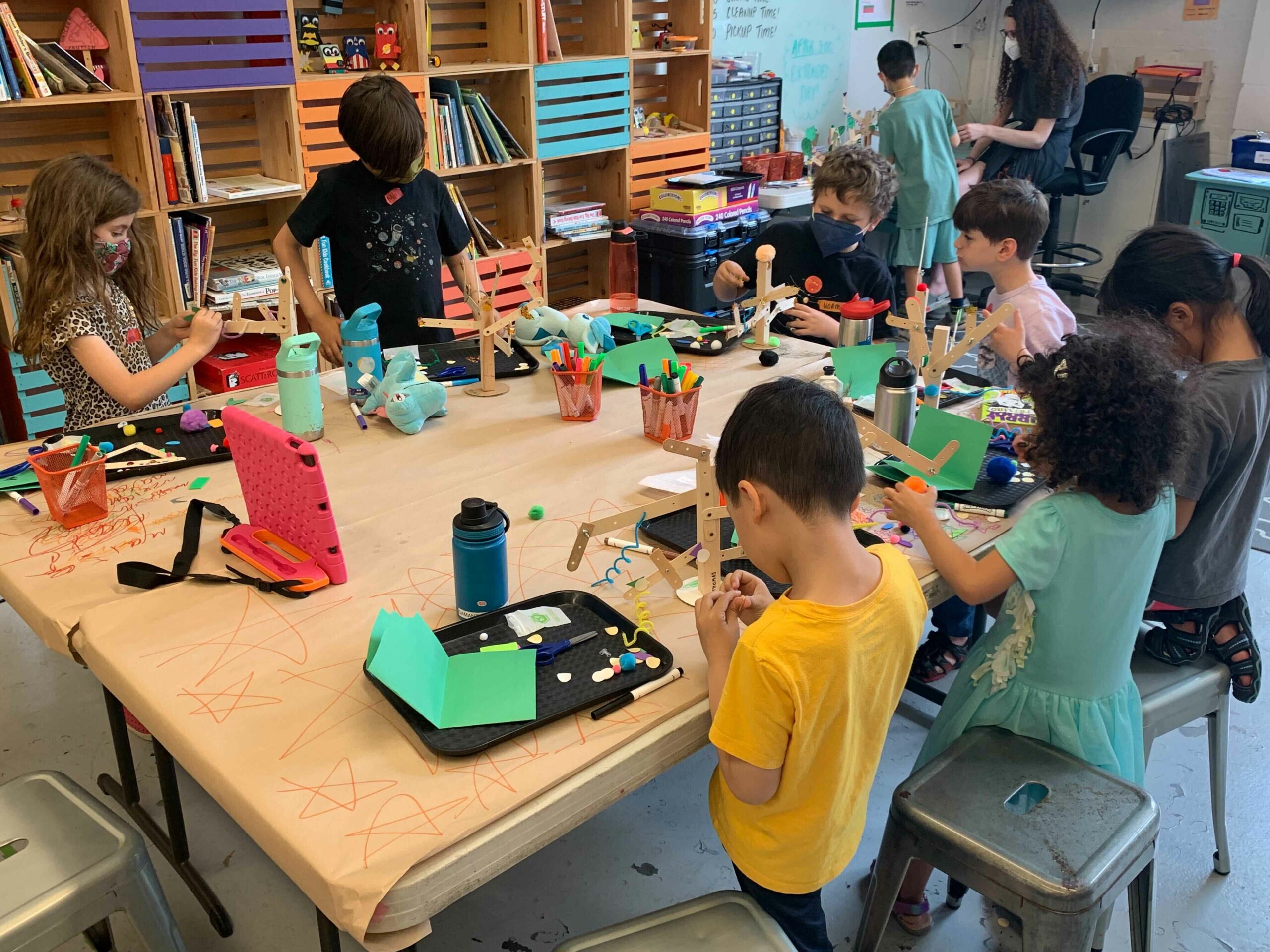 Children building robots at a table