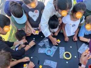 Children and parents participating in a hands-on Mini Bot building workshop