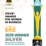 A graphic with a silhouetter of the Stevie Award onlong the side. There is a Brooklyn Robot Foundry logo and the Stevie Awards for Women in Business logo. The following words appear: STEVIE® AWARDS FOR WOMEN IN BUSINESS 2025 WINNER SILVER Achievement in Education for Girls and Young Women