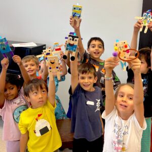 Photo of group of children holding up their finished robots